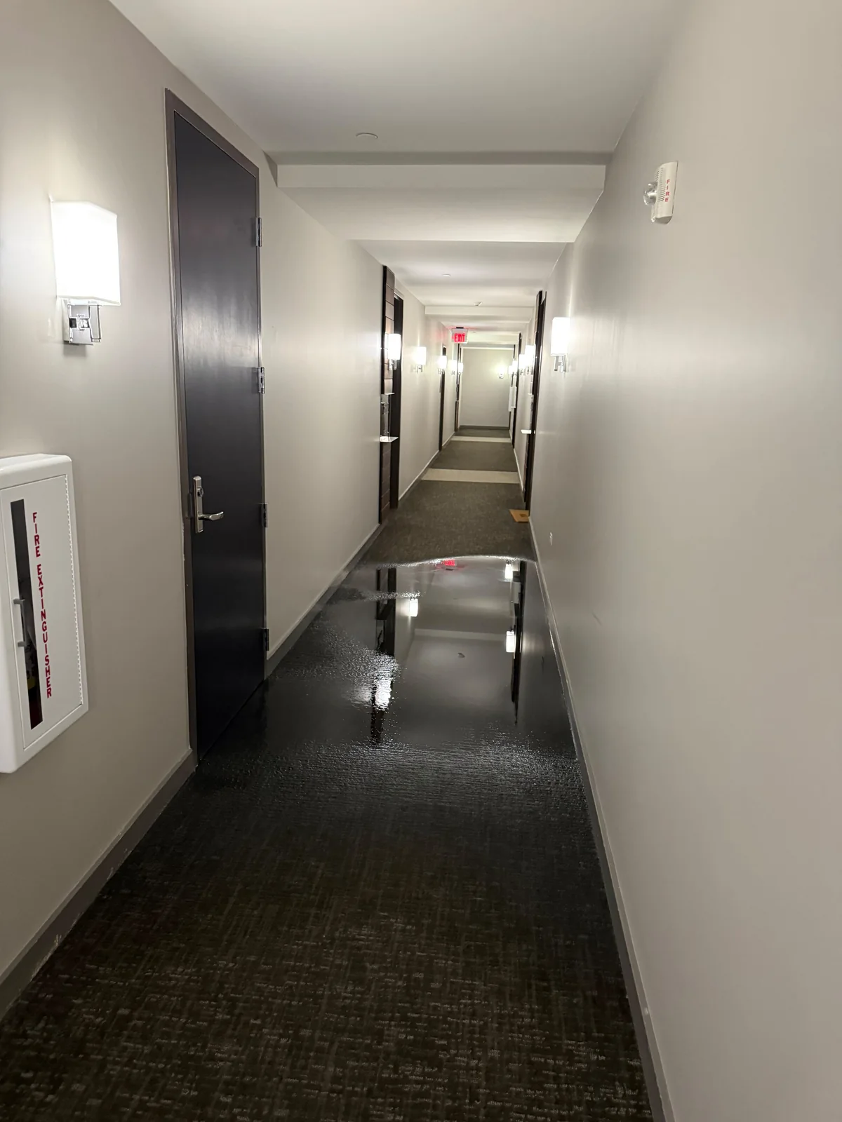 Water on the floor of an interior corridor at The Bowie after the fire